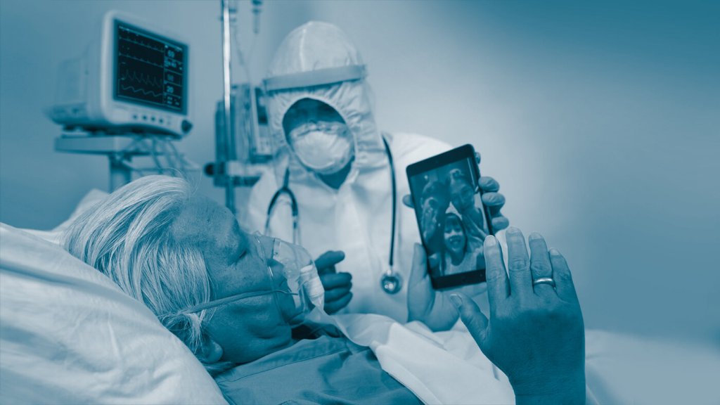 The image shows an intensive care patient with a mask communicating with his family on an iPad.