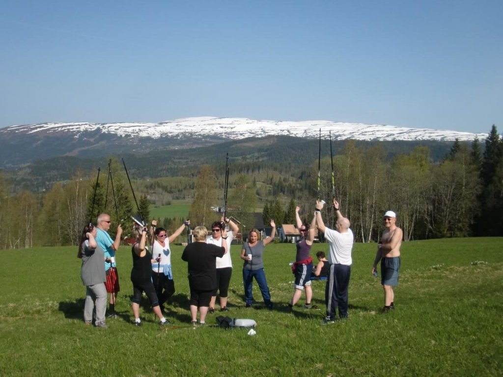 Bildet viser en gruppe pasienter som trimmer utendørs i vakker natur